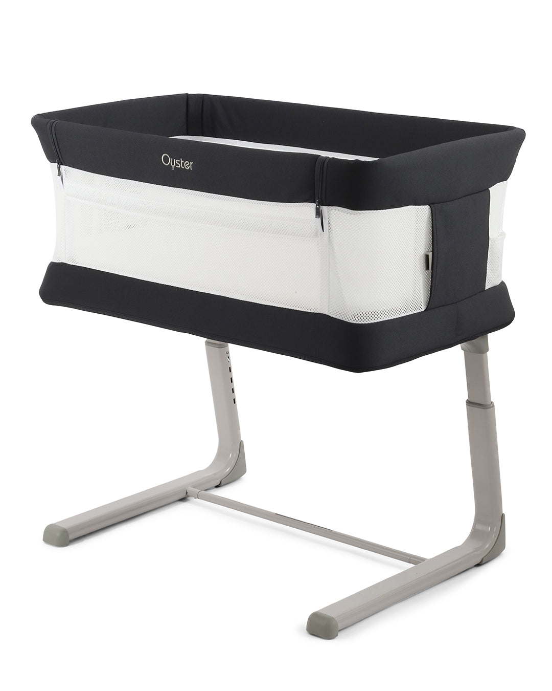 Oyster Wiggle Crib Co-Sleeper in Carbonite grey positioned beside a parent's bed for safer room sharing